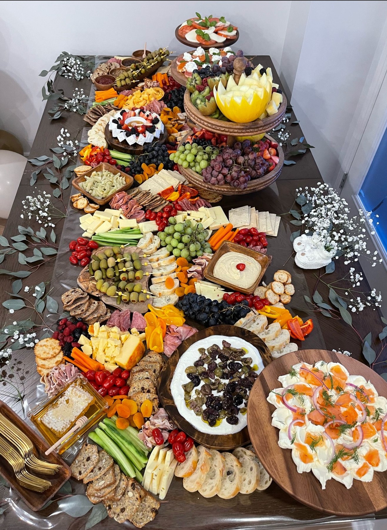 Elaborate grazing table with multiple tiers and varieties
