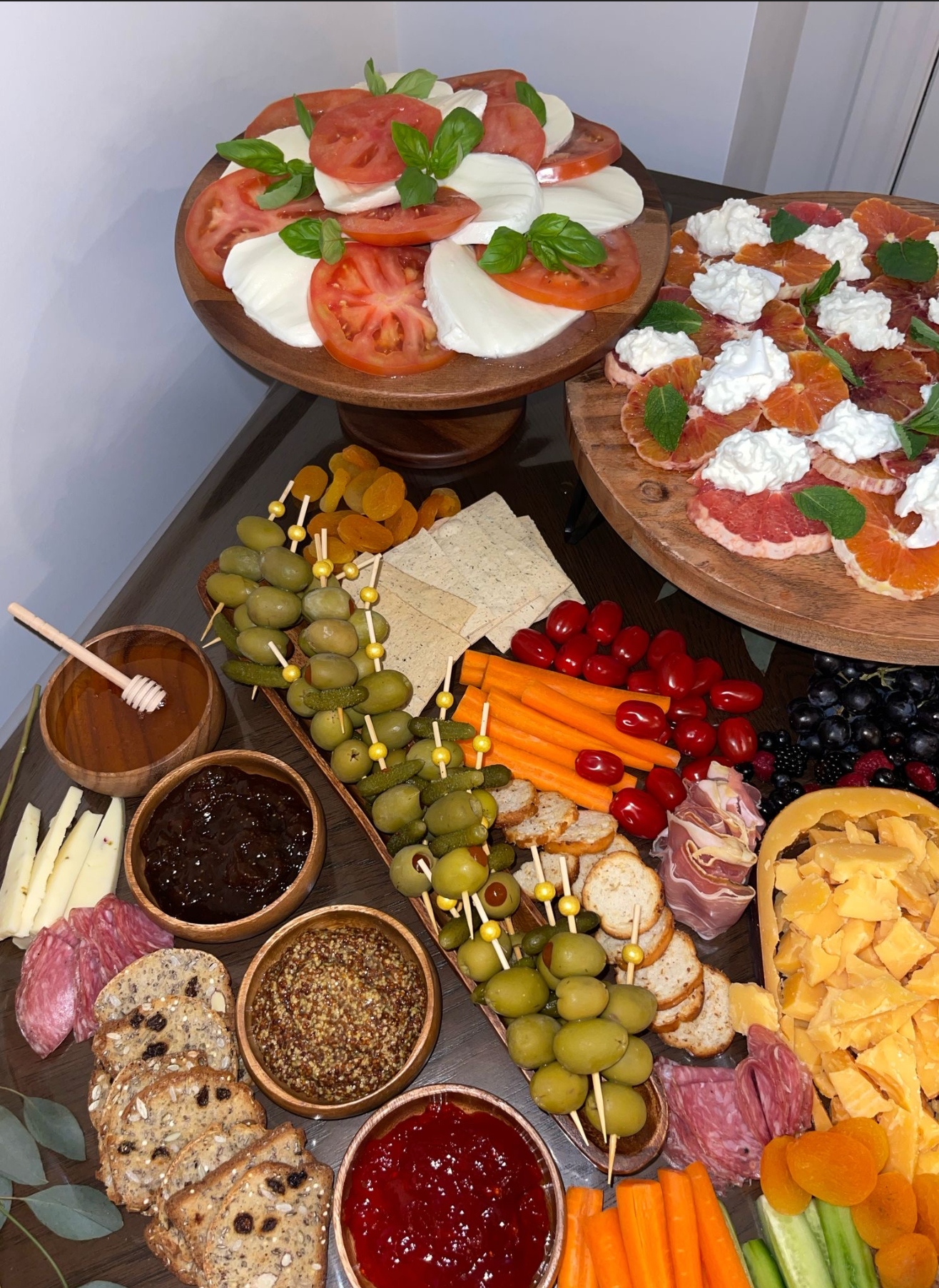 Grazing table featuring caprese and citrus displays
